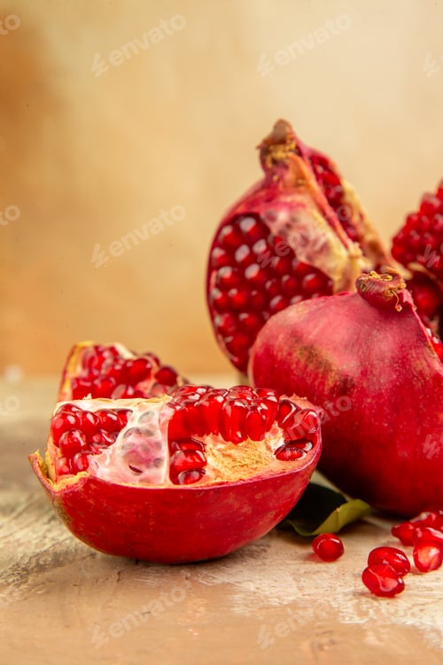 Preview: Top view (pomegranate) divided into 4 parts scattered seeds on the background free space for text
