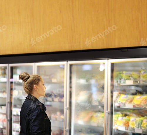 Preview: Woman Choosing Frozen Food From A Supermarket Freezer