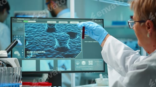 Preview: Laboratory scientist working with blood test late at night