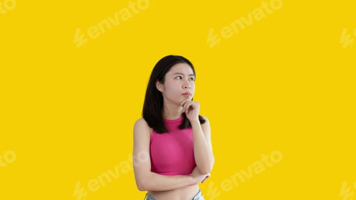 Preview: Young Asian woman thinking hard or planning to do something