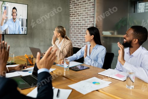 Preview: Videoconference Concept. Multiethnic business people making video call with colleague in office