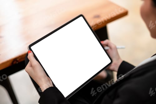 Preview: Close-up of woman working with stylus on digital tablet pc with blank white screen