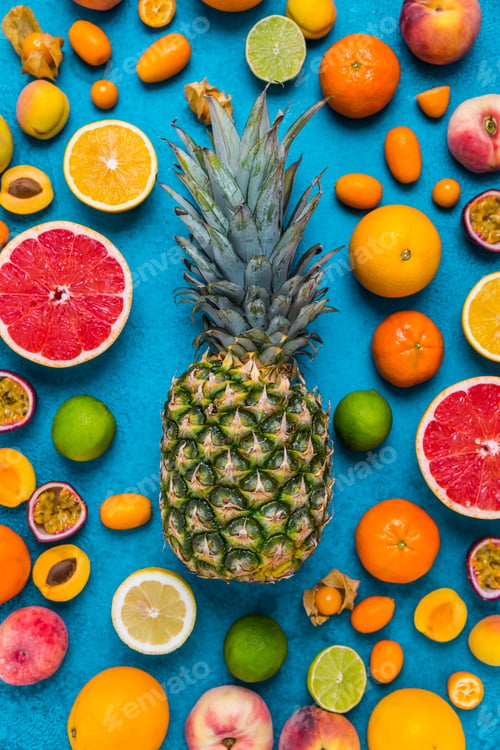 Preview: Flat lay layout of summer and citrus fruits on blue background