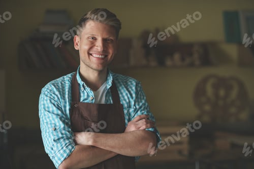Preview: Young master in an apron in carpentry