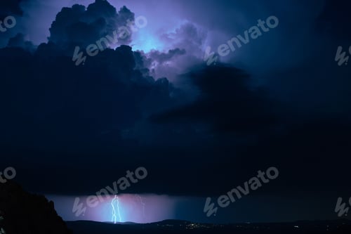 Preview: Mesmerizing view of a dramatic stormy cloudy sky at night with striking lightning