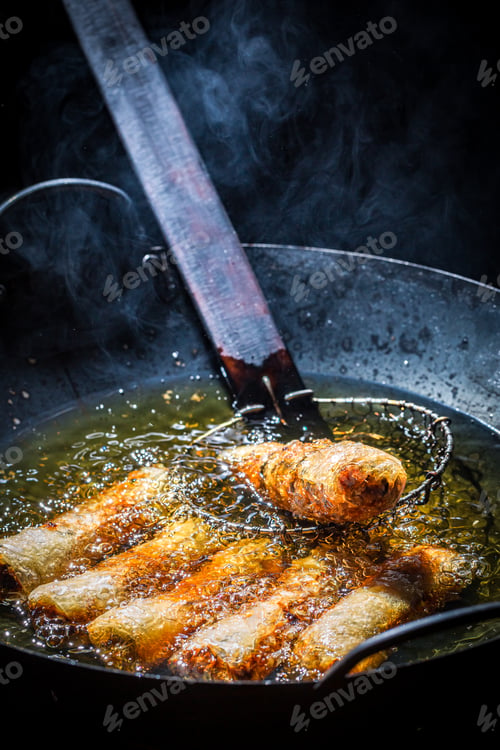 Preview: Homemade spring rolls frying in hot oil. Vietnamese cuisine.