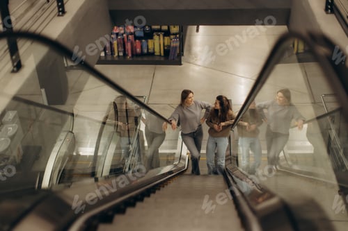 Preview: Two Women Chatting on an Escalator in a Modern Shopping Center