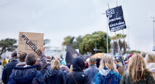Preview: Unrecognisable demonstrators holding up signs and protesting against the Covid 19 vaccine