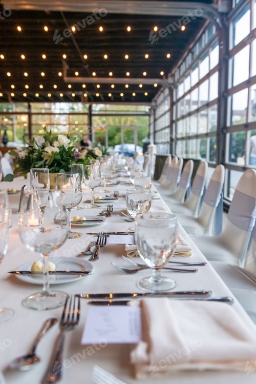 Preview: Vertical shot of a table setting at the wedding venue with a blurred background