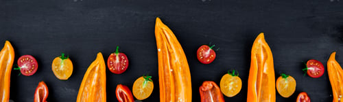 Preview: Banner of Mixed of half red and yellow pepper with a green branch near cherry tomato
