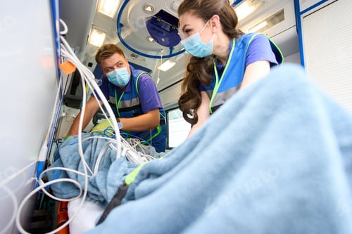 Preview: Man and woman in medical uniform fix patient with seat belts