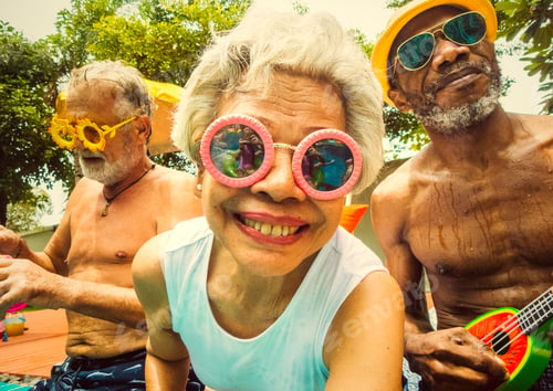 Preview: Closeup of diverse senior adults sitting by the pool enjoying su