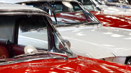 Preview: Dolly shot of vintage retro car hoods painted in red and white. Old transport exhibition or auction