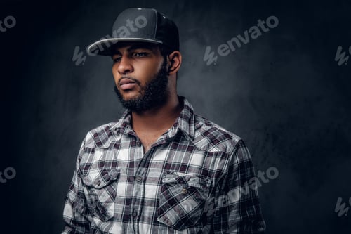 Preview: A man dressed in a fleece shirt and baseball cap.