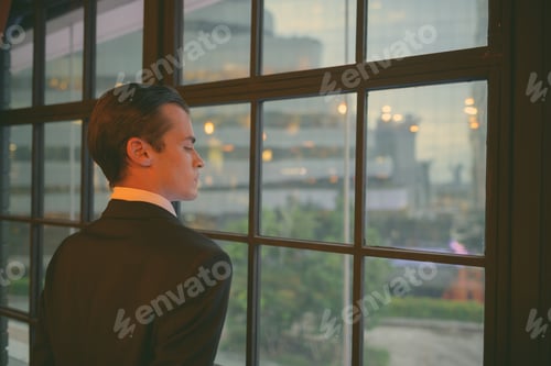 Preview: Young handsome businessman in suit exploring the city