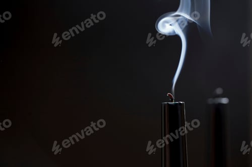 Preview: Close up of smoking black candle