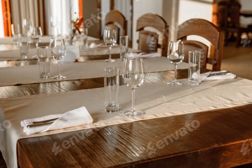 Preview: Glasses, flower fork, knife served for dinner in restaurant with cozy interior