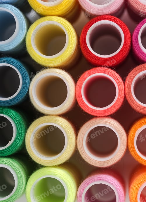 Preview: Background from bobbins with multicolored thread