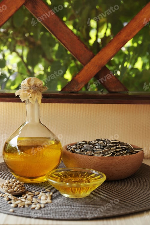Preview: Organic sunflower oil and seeds on white table