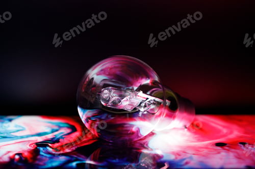 Preview: Intriguing colorful light emanating from a light bulb in a dimly lit setting