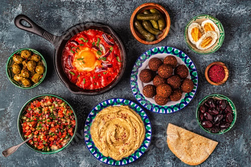 Preview: Falafel, hummus, shakshuka, Israeli salad - traditional dishes of Israeli cuisine.