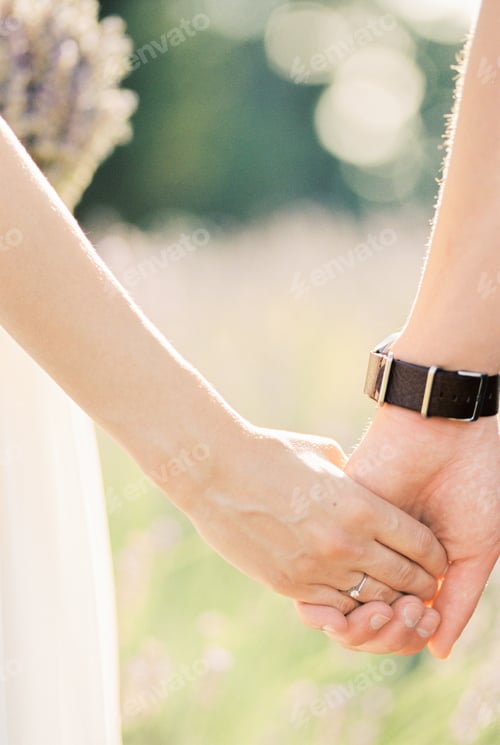 Preview: Groom holds bride hand. Close-up. Cropped