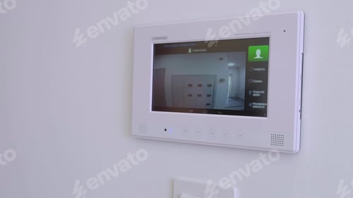 Preview: smart home, a man answers a call to the intercom, side view. Monitoring, unlock. Apartment video