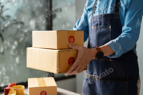 Preview: Business owner organizing packages for online sales.