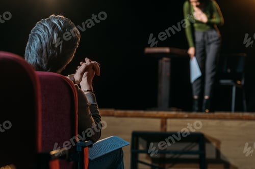 Preview: selective focus of theater director applauding to professional actress on stage