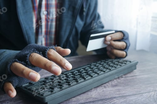 Preview: hacker hand stealing data from credit card