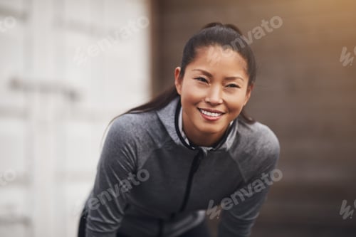 Preview: Fit young Asian woman in sportswear out for a run