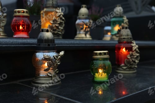 Preview: Grave lights on granite surface at cemetery
