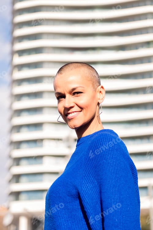 Preview: empowered woman smiling looking at camera