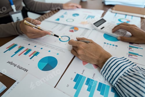 Preview: Business Team Analyzing Financial Graphs and Charts, High-Angle View Concept of financial analysis