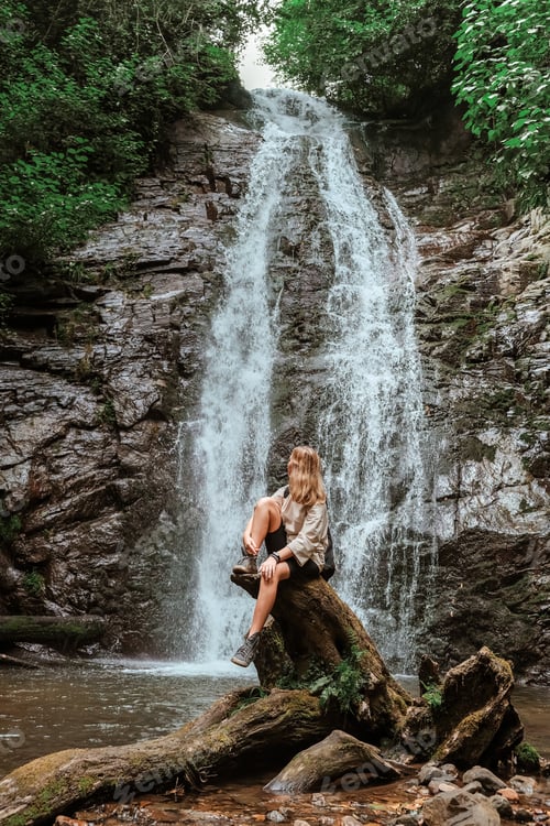Preview: Travel. Girl travels through the mountains and waterfalls of wild nature. Unity, mental health, eco