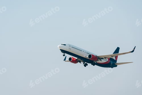 Preview: Commercial airplane taking off with clear sky at background