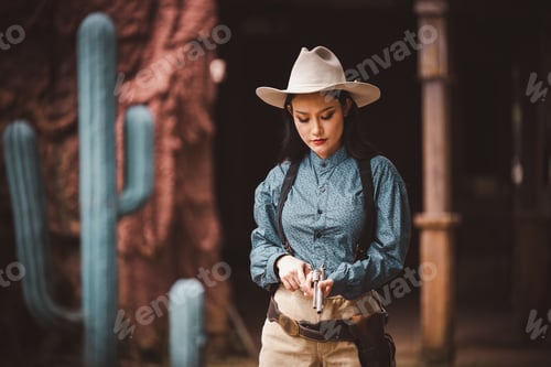 Preview: Cowboy posing shooting rifle by gun on hand to show protected weapon wearing cowboy dresser and hat