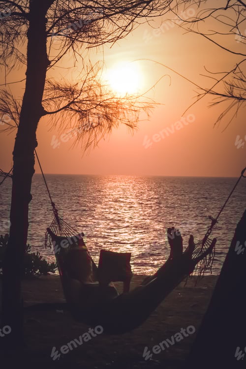 Preview: Relaxing in a hammock on a beach at sunset