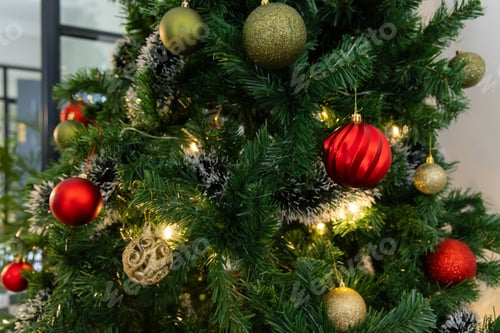 Preview: Festive Christmas tree decorated with colorful ornaments and glowing lights, at home