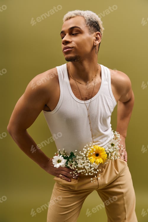 Preview: Young African American man showcases trendy floral style in a vibrant studio setting