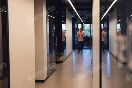 Preview: Caucasian mature businessman walking in corridor of creative office