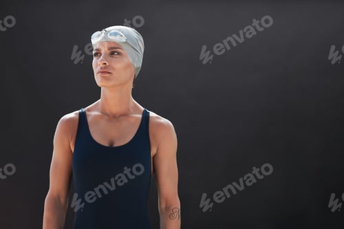Preview: Fit young female swimmer looking away