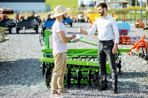 Preview: Agronomist with salesman at the shop with agricultural machinery