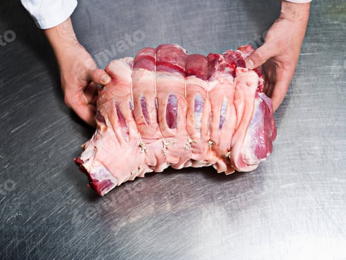Preview: A butcher holding a piece of meat
