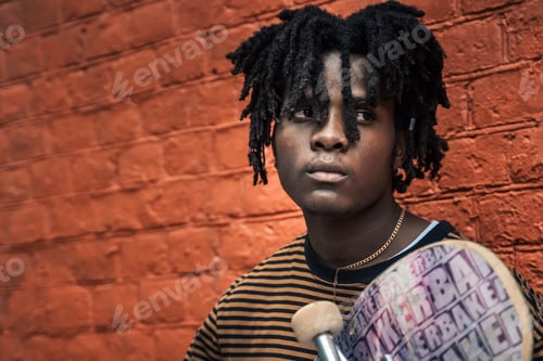 Preview: Portrait of young handsome stylish black man with natural hair dreadlocks. Afroamerican guy. Wall pa