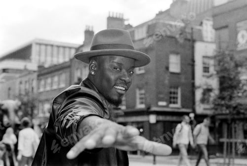Preview: Monochrome portrait of expressive man with hat being shot with flash.