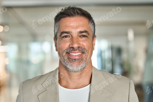 Preview: Happy middle aged business man standing in office. Headshot portrait