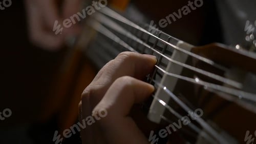 Preview: Close up of guitarist hand playing acoustic guitar. Close up shot of a man with his fingers on the