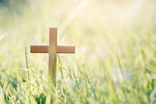 Preview: Cross on blurry sunset background.