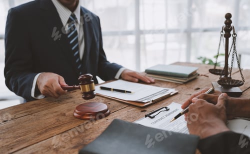 Preview: An attorney or legal advisor is carefully reading the validity of investment documents and signing a